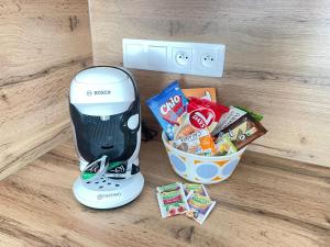 a blender sitting next to a basket of candy at Central Comfort Studio Walkup in Slezská Ostrava