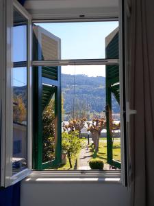 an open window with a view of a garden at Albergo La Maria in Fiumaretta di Ameglia