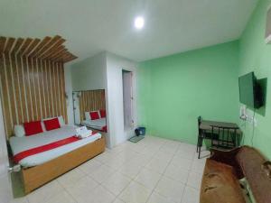 a bedroom with a bed and a desk in it at MCT Hotel in Manila