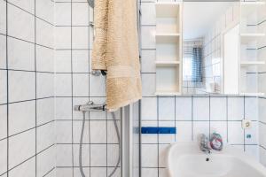 a bathroom with a shower and a sink at Möve Aba Bungalow 66 in Rerik +19 photos