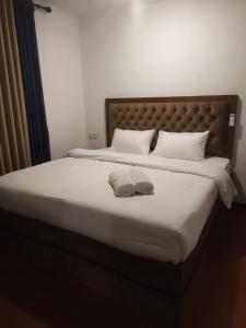 a bedroom with a bed with two towels on it at Thotupala Eco Lodge in Nilweligama