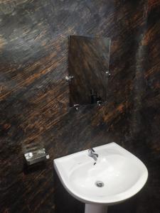 a bathroom with a white sink and a mirror at Thotupala Eco Lodge in Nilweligama