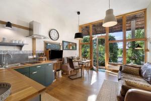 a kitchen and living room with a couch and a table at Ferienwohnung Zur Alten Scheune in Balingen