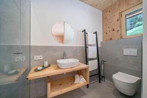 a bathroom with a sink and a toilet at Naturapartments Alpreid Zirbe in San Pancrazio dʼUltimo +12 photos