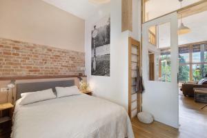 a bedroom with a bed and a brick wall at Ferienwohnung Zur Alten Scheune in Balingen