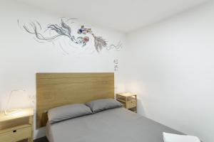 a bedroom with a bed with a painting on the wall at Casa Isabel eccezionale Vista Mare in Mogán +20 photos