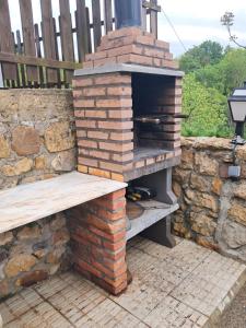 a brick oven with a bench on a patio at Casa Elena in Cangas de Onís