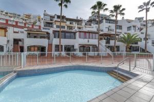 a swimming pool in front of a building at Casa Isabel eccezionale Vista Mare in Mogán
