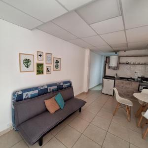 a living room with a couch and a table at C1 Suite in Las Varillas
