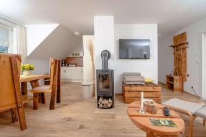 a living room with a wood stove in it at Ferienwohnung Heuschober in Neuendorf am See