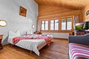 a bedroom with a bed and a flat screen tv at L'Auberge de L'Ours in Vers L'Eglise
