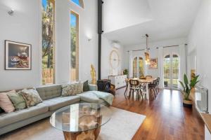 a living room with a couch and a glass table at Villa Playa Felostal in Palma de Mallorca
