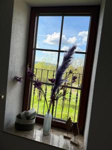 a window with a vase with flowers in it at Gästehaus Klausenhof in Klausen
