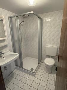 a bathroom with a shower and a toilet and a sink at Gästehaus Klausenhof in Klausen +13 photos