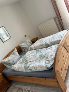 a bedroom with a bed with a wooden frame at Gästehaus Klausenhof in Klausen