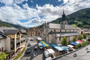 an aerial view of a town with a church at Résidence du parc in Thônes