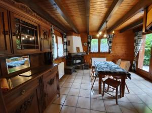 a kitchen with a table and chairs in a room at Chalet Du Saix - Sauna in La Chapelle-dʼAbondance +7 photos