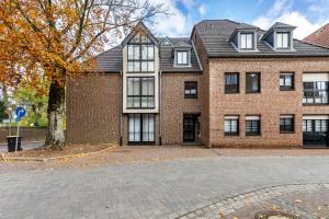 a brick building with a tree in front of it at Ferienwohnung an der Kriemhildmühle in Xanten