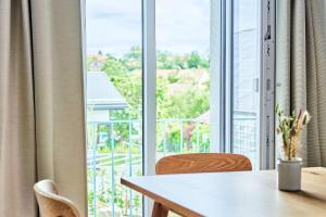 a table and chairs in front of a large window at Alte Seifensiederei - Thay in Bad Tölz