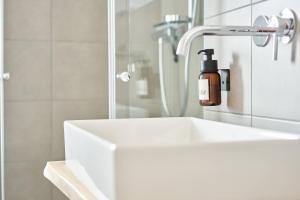 a bathroom sink with a bottle of soap on it at Alte Seifensiederei - Thay in Bad Tölz