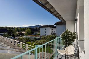 a balcony with two chairs and a view at Alte Seifensiederei - Thay in Bad Tölz
