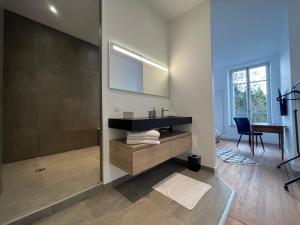 a bathroom with a sink and a mirror at L'aristide in Épinal +8 photos