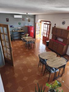 a room with tables and chairs and a kitchen at B&B Relax Gonone in Cala Gonone