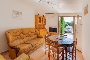 a living room with a couch and a table at Les Sources Gîte La Remise in Chambonas