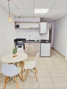 a kitchen with a table and chairs in a room at C1 Suite in Las Varillas +16 photos
