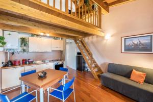 a kitchen and a living room with a couch and a table at Residence La Piopa in Polpenazze del Garda