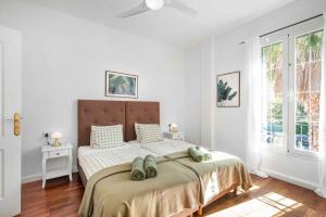 a bedroom with a large bed with a ceiling fan at Villa Playa Felostal in Palma de Mallorca +43 photos