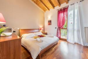 a bedroom with a bed and a large window at Residence La Piopa in Polpenazze del Garda +12 photos
