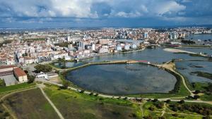 an aerial view of a city with a large body of water at Lisbon south side apartments in Barreiro