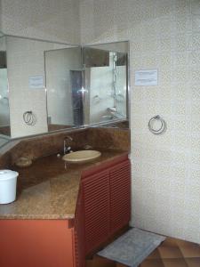 a bathroom with a sink and a mirror at Reisnger Hostel in Rio de Janeiro