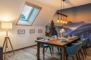 a dining room with a wooden table and chairs at Appartement Bergblick in Stockach