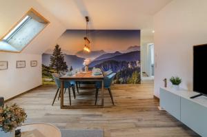 a dining room with a large painting on the wall at Appartement Bergblick in Stockach