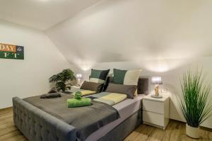 a bedroom with a large bed with a green pillow on it at Appartement Bergblick in Stockach +33 photos