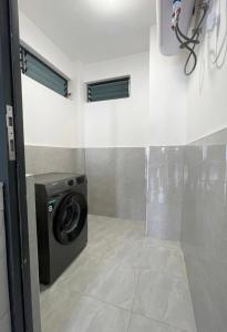 a laundry room with a washing machine in a room at Shangri-la residence Westlands-Remote working & gym in Nairobi