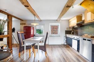 a kitchen with a table and chairs in a room at Wünsch Dir was in Großweitzschen
