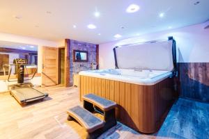 a large bathroom with a tub and two stools at Gentiane in Valloire