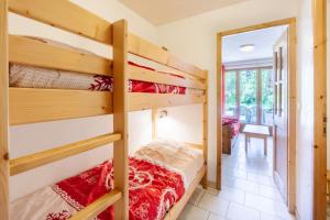 a bedroom with two bunk beds and a hallway at Gentiane in Valloire