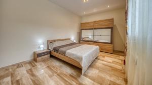 a bedroom with a bed and a large mirror at Costacabana - Villa Madison in Lloret de Mar