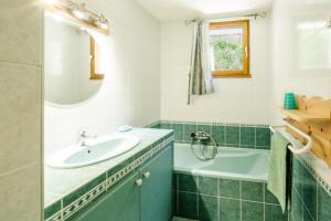 a bathroom with a sink and a tub at Gentiane in Valloire +14 photos