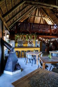 a restaurant with wooden tables and a bar at StableWood Lodge in Kimberley