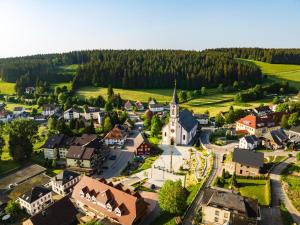 an aerial view of a small town with a church at Ferienwohnungen Uhren Allgaier in Schönwald