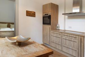 a kitchen with wooden cabinets and a wooden table at Kurfürstensuite in Brandenburg an der Havel