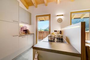 a kitchen with a white refrigerator and a counter at Masi Lavendel in Santa Valpurga