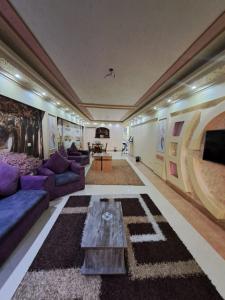a living room with a couch and a table at SARAYA AWAD HEGAZI STREET- families only in Alexandria