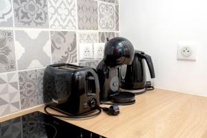 a counter with two coffee pots and affeepot on it at Chez Pierre et Germaine in Saint-Maurice-de-Rotherens