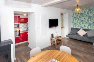 a living room with a couch and a table at Chez Pierre et Germaine in Saint-Maurice-de-Rotherens